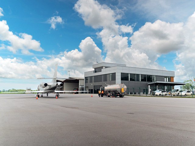 A business jet and a fuel truck on the apron in front of the EAG terminal