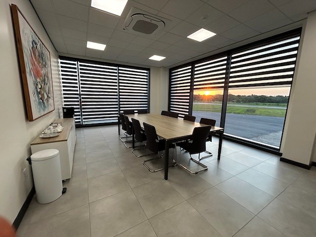 The EAG boardroom at sunset, the apron visible through the louvred glazing